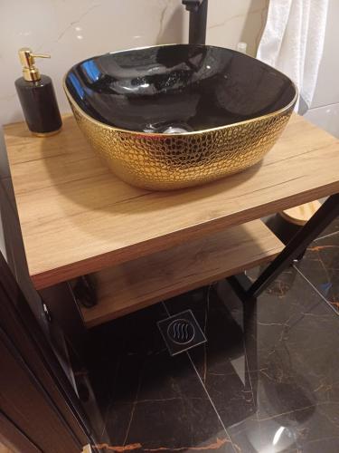 a black bowl sitting on a wooden table at Villa Sky D 9&1 with tennis court and heated pool in Omiš