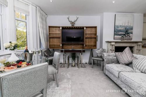 a living room with a couch and a piano at Central Park Suite by Grandeur Property in Parkstone