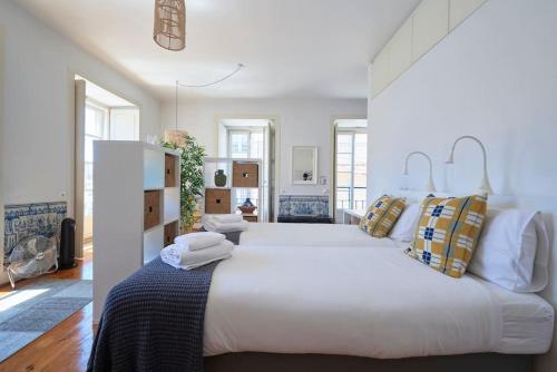 a large white bedroom with a large white bed at Inglesinhos Convento 3 - Bright Apartment in Lisbon