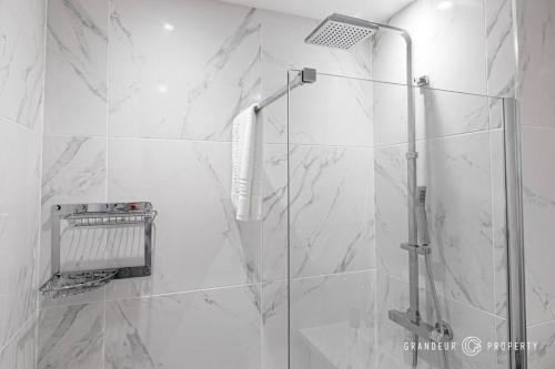 a bathroom with a shower with a glass door at Central Park Suite by Grandeur Property in Parkstone