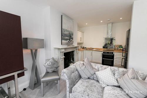 a living room with a couch and a fireplace at Central Park Suite by Grandeur Property in Parkstone