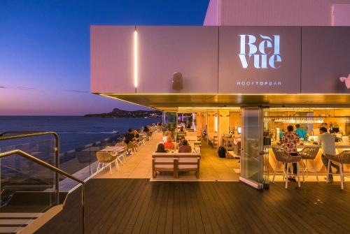 people sitting on the deck of a cruise ship at night at Amàre Beach Hotel Ibiza - Adults Recommended in San Antonio Bay