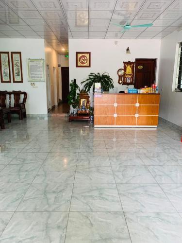 a lobby with a reception desk and a tile floor at Hotel Thuý đông in Sóc Sơn