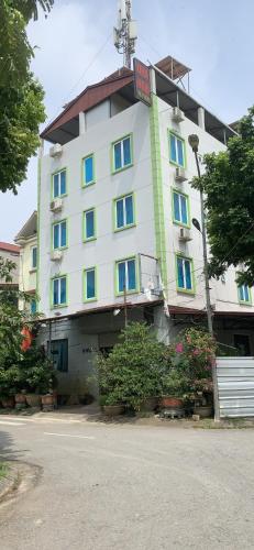 a large white building with a sign on it at Hotel Thuý đông in Sóc Sơn