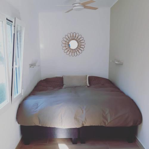 a bed in a bedroom with a mirror on the wall at Casa Vitalis in Vilamarxant