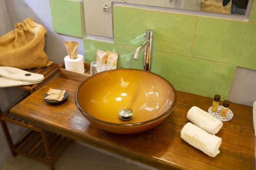 a bowl sink on a wooden counter in a bathroom at PORTA SOPRANA luxury guest House & spa in Sclafani