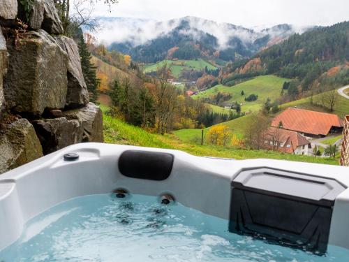 a bath tub with a view of a mountain at Ferienhaus Wendelinus mit Pool & Sauna in Hausach