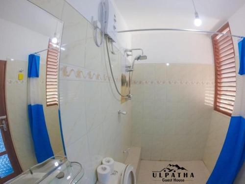 a bathroom with a shower and a toilet and a sink at Ulpatha Guest House in Hatton