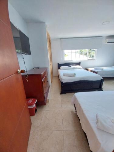 Postel nebo postele na pokoji v ubytování Hotel Sierra Nevada B&B SAS