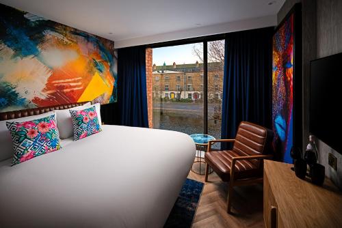 a bedroom with a large bed and a window at NYX Hotel Dublin Portobello in Dublin