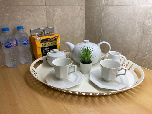 a tray with a tea pot and cups on a table at Spacious flat in the most desirable area of London in London