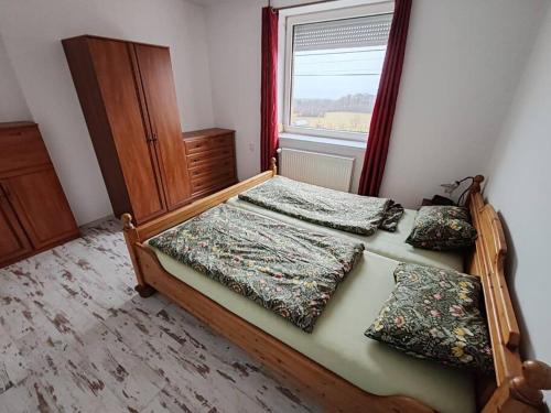 a bedroom with two beds and a window at Apartmán u Kulíška in Prievidza