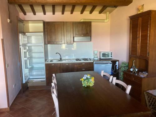 a kitchen with a table with flowers on it at appartamento Colticciola Agriturismo Marche in Cagli
