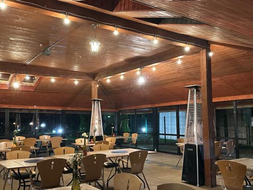 a banquet hall with tables and chairs and lights at Hotel Hetman in Kroczyce