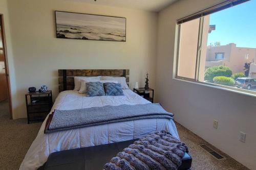 a bedroom with a bed and a large window at Home near Balloon Fiesta Park! in Albuquerque