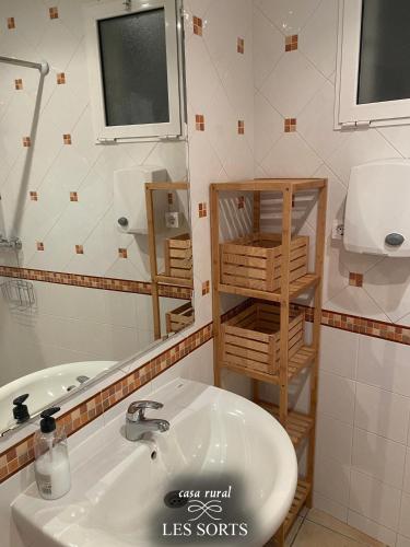 a bathroom with a sink and a mirror at Casa rural Les Sorts in Rosell