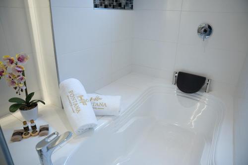 a bathroom sink with a roll of toilet paper on it at Hotel Fontana Bogotá - Corferias in Bogotá