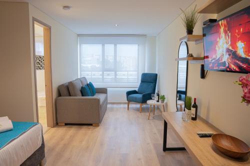 a living room with a couch and a chair at Hotel Fontana Bogotá - Corferias in Bogotá