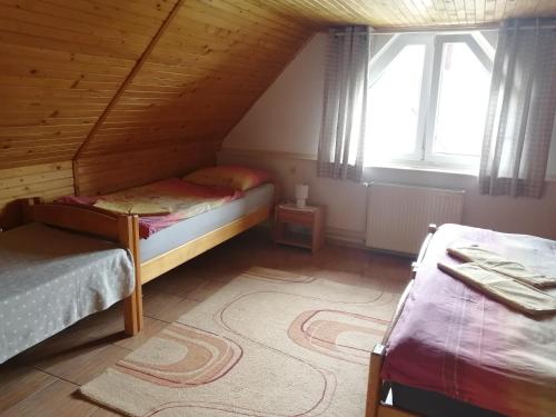 a bedroom with two bunk beds in a attic at Domček u Vojta in Habovka