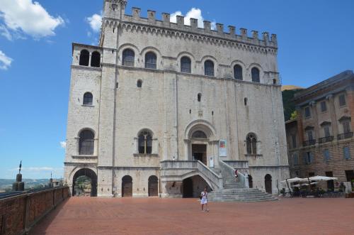 a woman standing in front of a large building at appartamento Colticciola Agriturismo Marche in Cagli