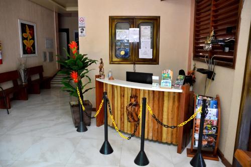 a lobby with a counter in the middle of a building at Pousada Cabocla in Alter do Chao