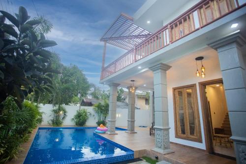 a villa with a swimming pool and a house at Ran Villa in Ahangama