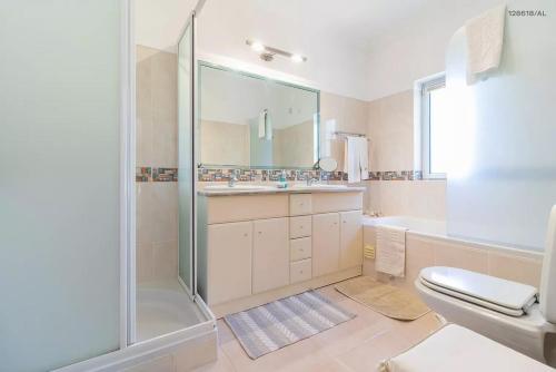 uma casa de banho com um chuveiro, um WC e um lavatório. em Pestana Carvoeiro Golfe - AL em Carvoeiro