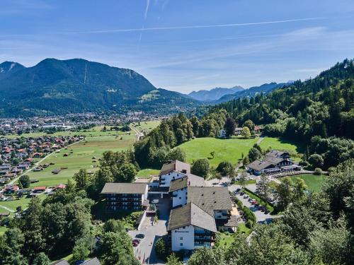 an aerial view of a resort in the mountains at Riessersee Hotel in Garmisch-Partenkirchen