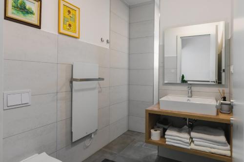a white bathroom with a sink and a mirror at Villa Boiky - private pool and amazing sea view, Istria in Materada