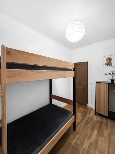 une chambre avec un lit superposé dans une pièce dans l'établissement Un Coin Tranquille de Bagneux, à Bagneux
