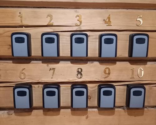 a wooden wall with a bunch of numbers on it at S Neries 19 apartamentai su parkingu in Šiauliai