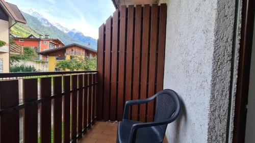 a blue chair sitting on a balcony with a fence at Albergo Meublé Aurora in Edolo