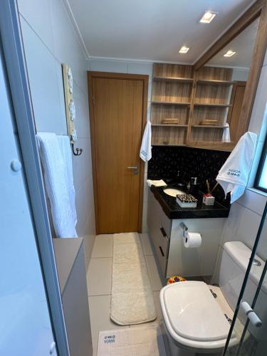 a small bathroom with a toilet and a sink at Muro Alto Makia flat cinematográfico in Porto De Galinhas