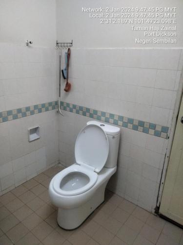 a bathroom with a toilet with the lid up at Ground floor apartment Seaview beach in Port Dickson