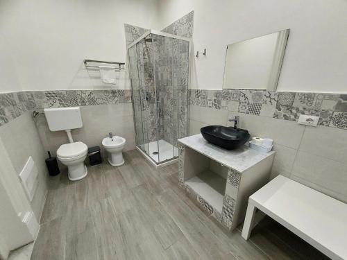 a bathroom with a sink and a toilet and a shower at La Casa del Moro - All' Operà in Palermo