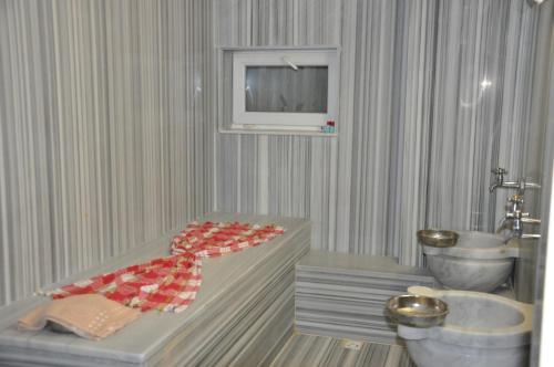 a bathroom with a tub and a sink and a tv at Island Hotel in Istanbul