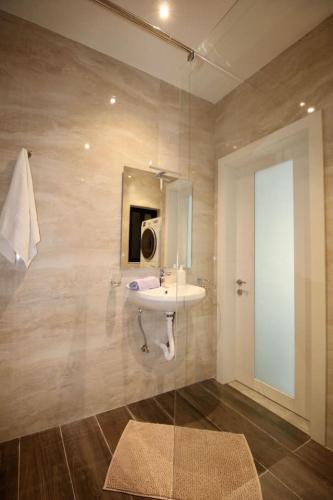 a bathroom with a sink and a mirror at Gzira 3 bedroom apartment in Il-Gżira