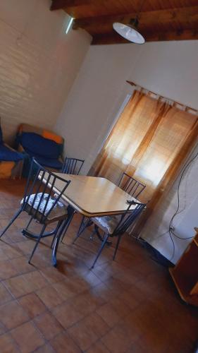 a table and chairs in a room with a window at Barbi Room in Guaymallen