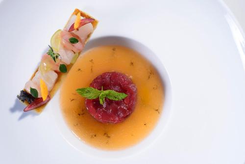a white plate with a piece of food on a plate at La Plage Resort in Taormina