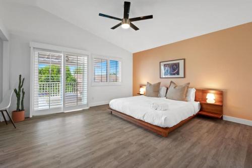 a bedroom with a large bed and a ceiling fan at The Modern Indio Large Family Home With Pool And Spa in Indio