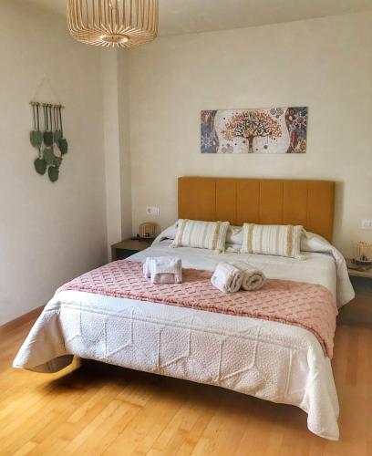 a bedroom with a large bed with towels on it at Ekhiola Txiki in Ochagavía