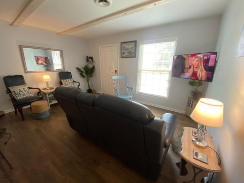 a living room with a couch and a table at Smooth Sailing on Lake Waccamaw in Lake Waccamaw
