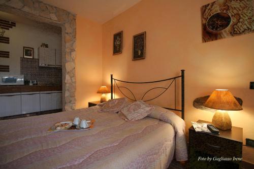 a bedroom with a bed with a plate of food on it at B&B Le Palme d'Oro in Grisignano di Zocco