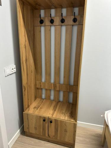 a wooden cabinet in the corner of a room at Hostel O2 in Almaty