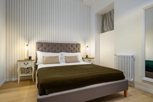 a bedroom with a large bed and two night stands at Classbnb - 2 bilocali di design in zona Porta Garibaldi in Milan