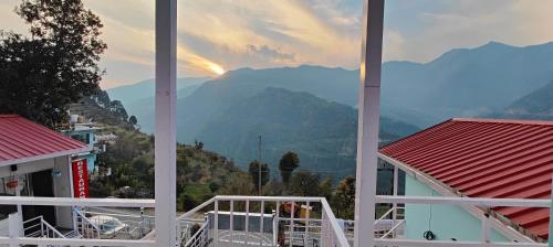 a view of the mountains from the balcony of a building at Belle Vue Chopta in Barmoāri