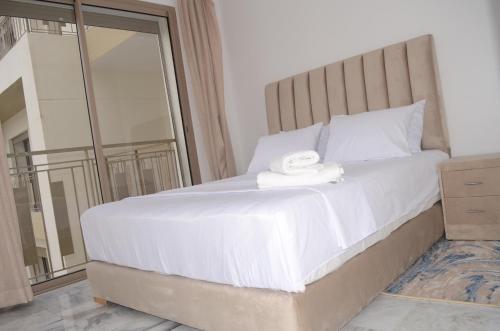 1 dormitorio con 1 cama blanca grande y espejo en Luxury apartment fully furnished en Casablanca