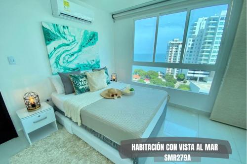 a bedroom with a bed with a dog on it at Apartamentos Neos - Cerca al Mar by SOHO in Santa Marta