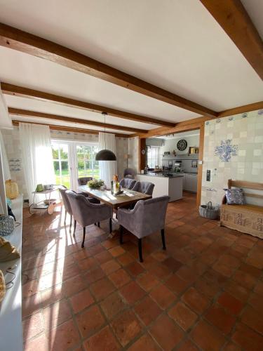 a kitchen and dining room with a table and chairs at Landhaus Lotten in Winsen Luhe
