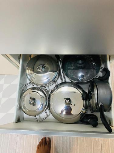 a bunch of pots and pans in a drawer at Holiday Escape Philippines in Manila